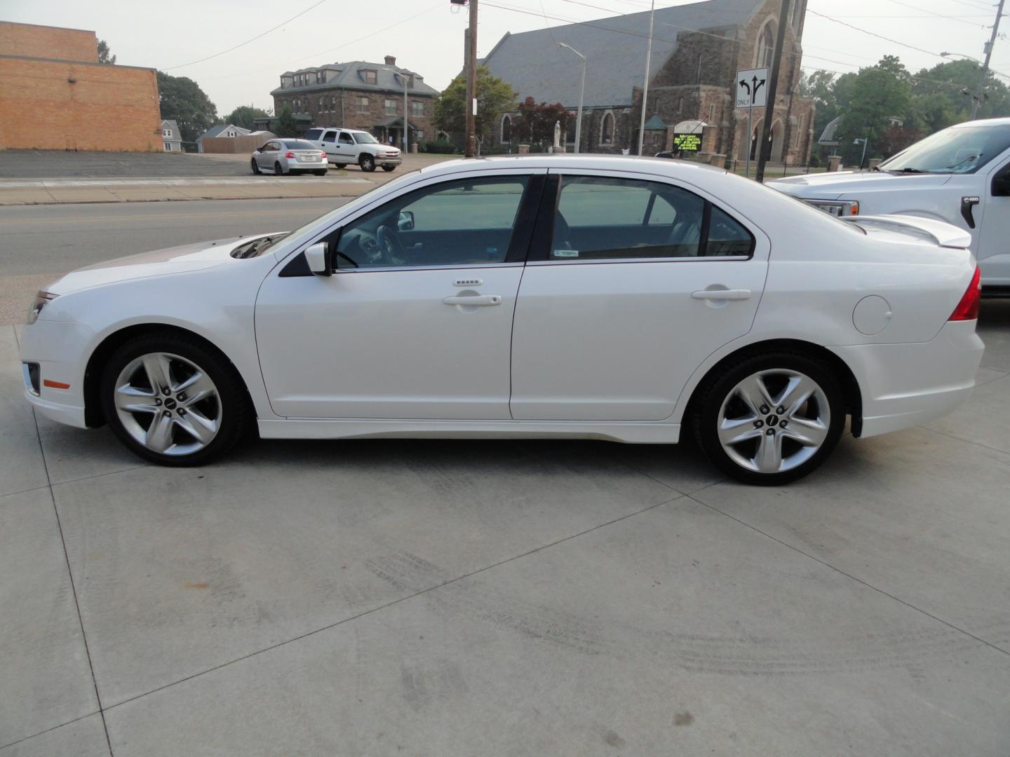 2012 White Platinum Tricoat /Jet Black Ford Fusion SPORT (3FAHP0KC4CR) with an 3.5L V6 DOHC 24V engine, 4-Speed Automatic Overdrive transmission, located at 827 W 26th Street, Erie, PA, 16508, (814) 455-3401, 42.105431, -80.090942 - Thanks for looking at our super clean rust and accident-free trade in. We sold this vehicle a few years ago and just took it back in on trade, and it's in the best condition I've seen in years with a rust-free exterior as well as a like new interior. This is the Sport model with the V-6 motor, dual- Photo#6