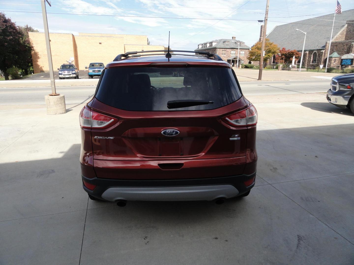2014 Sunset Metallic /Greystone Ford Escape SE 4WD (1FMCU9GX3EU) with an 1.6L L4 DOHC 16V engine, 6-Speed Automatic transmission, located at 827 W 26th Street, Erie, PA, 16508, (814) 455-3401, 42.105431, -80.090942 - Thanks for looking at out two owner accident and rust-free new arrival. This is the SE model with all wheel drive, power drivers sear, panoramic sunroof, rear parking aids, back up camera, large touch screen and lots more. A full service was just completed in our service department with new Pa state - Photo#4