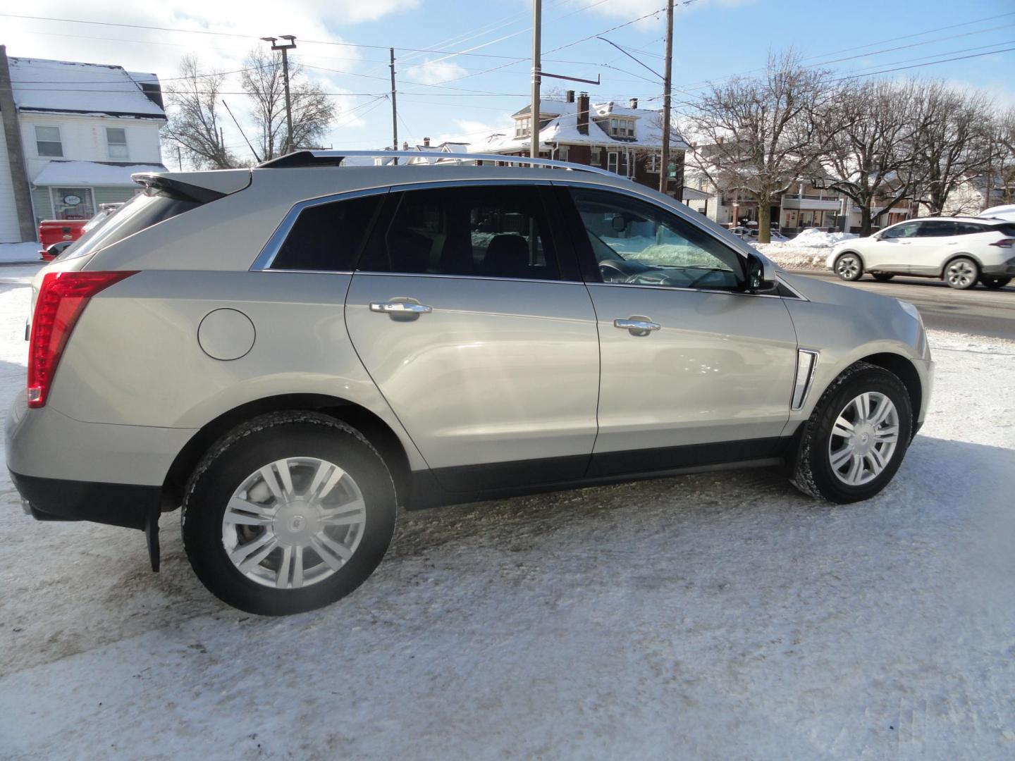 2015 Champagne Silver Metallic /Tan Cadillac SRX Luxury Collection FWD (3GYFNBE31FS) with an 3.6L V6 DOHC 24V FFV engine, 6-Speed Automatic transmission, located at 827 W 26th Street, Erie, PA, 16508, (814) 455-3401, 42.105431, -80.090942 - Thanks for looking at our low mileage accident-free new arrival and a recent trade in at a local Chevrolet dealership. This vehicle was originally sold new In Florida which explains the RUST FREE exterior as well as the like new nonsmoker interior plus it comes with lots of options and it also comes - Photo#3