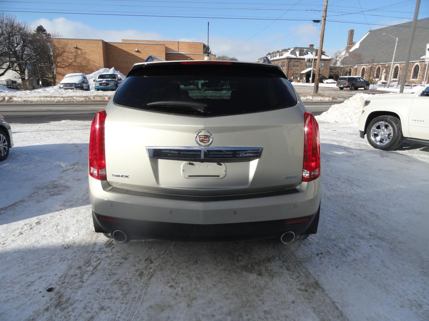2015 Champagne Silver Metallic /Tan Cadillac SRX Luxury Collection FWD (3GYFNBE31FS) with an 3.6L V6 DOHC 24V FFV engine, 6-Speed Automatic transmission, located at 827 W 26th Street, Erie, PA, 16508, (814) 455-3401, 42.105431, -80.090942 - Thanks for looking at our low mileage accident-free new arrival and a recent trade in at a local Chevrolet dealership. This vehicle was originally sold new In Florida which explains the RUST FREE exterior as well as the like new nonsmoker interior plus it comes with lots of options and it also comes - Photo#4