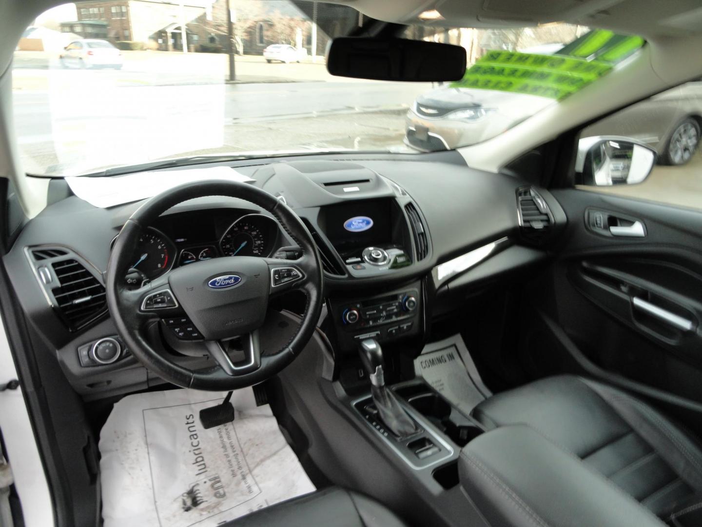 2017 White Titanium /Jet Black Ford Escape Titanium 4WD (1FMCU9JD7HU) with an 1.5L L4 DOHC 16V engine, 6-Speed Automatic transmission, located at 827 W 26th Street, Erie, PA, 16508, (814) 455-3401, 42.105431, -80.090942 - Thanks for looking at our one owner accident and rust-free new arrival. This is the top-of-the-line Titanium model with four-wheel drive, dual power heated leather front seats, remote start, back up camera, push button start, lane departure. blind spot monitor and lots more including two sets of fac - Photo#9