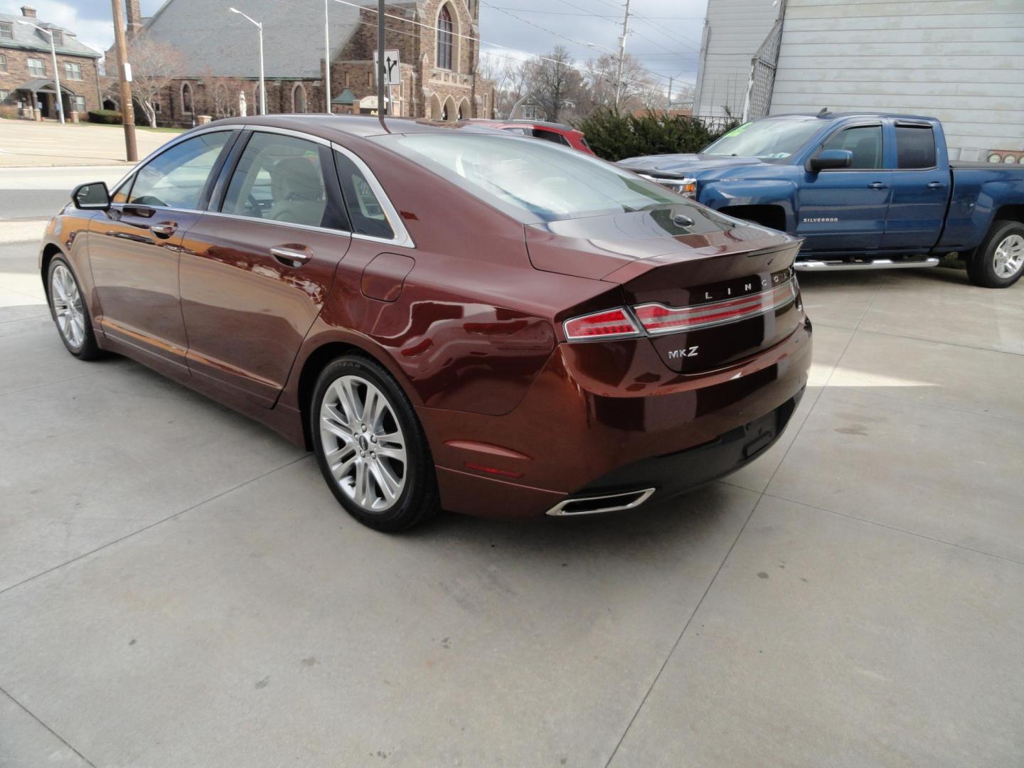 2015 Ruby Red Metallic /Tan Lincoln MKZ Hybrid Sedan (3LN6L2LU5FR) with an 2.0L L4 DOHC 16V HYBRID engine, Continuously Variable Transmission transmission, located at 827 W 26th Street, Erie, PA, 16508, (814) 455-3401, 42.105431, -80.090942 - Thanks for looking at our low mileage great on gas recent trade in. This is the Hybrid edition with lots of options in like new condition with a great exterior as well as a like new interior plus it comes with both keyless remotes, remote start and the factory owner's manuals. A full service was jus - Photo#5
