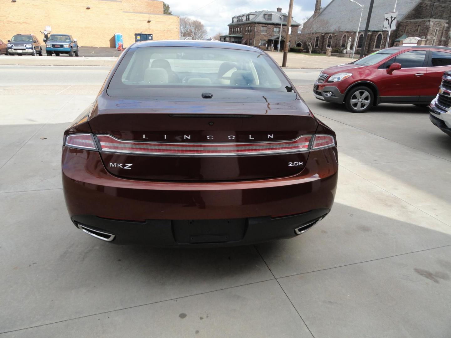 2015 Ruby Red Metallic /Tan Lincoln MKZ Hybrid Sedan (3LN6L2LU5FR) with an 2.0L L4 DOHC 16V HYBRID engine, Continuously Variable Transmission transmission, located at 827 W 26th Street, Erie, PA, 16508, (814) 455-3401, 42.105431, -80.090942 - Thanks for looking at our low mileage great on gas recent trade in. This is the Hybrid edition with lots of options in like new condition with a great exterior as well as a like new interior plus it comes with both keyless remotes, remote start and the factory owner's manuals. A full service was jus - Photo#4