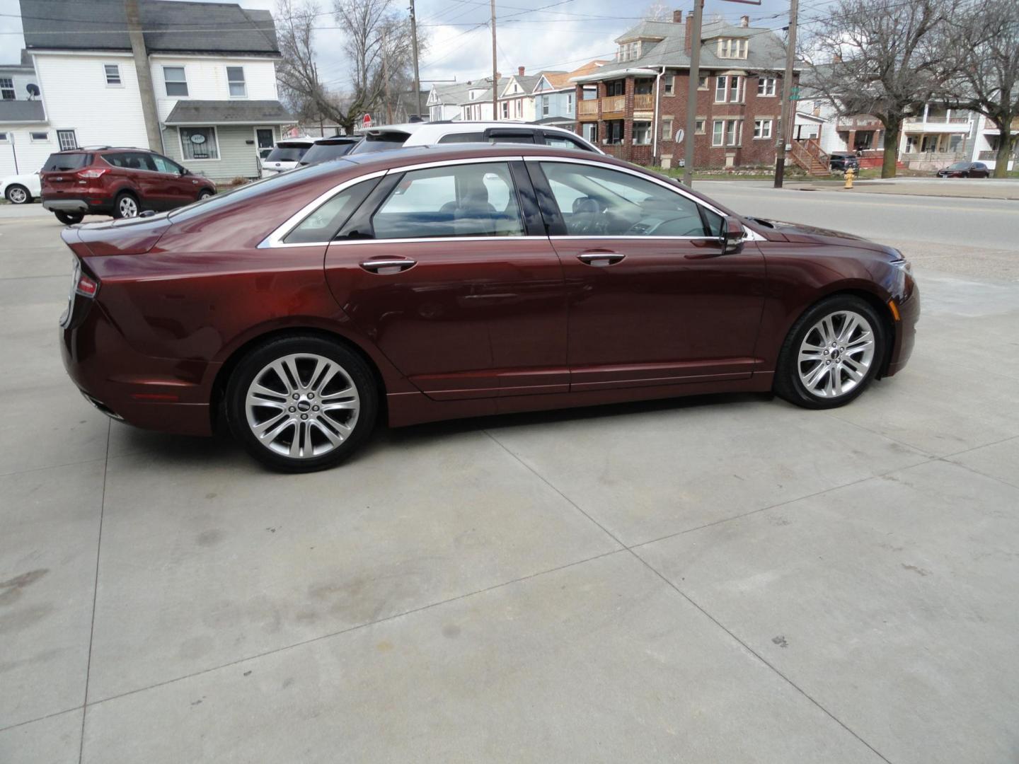 2015 Ruby Red Metallic /Tan Lincoln MKZ Hybrid Sedan (3LN6L2LU5FR) with an 2.0L L4 DOHC 16V HYBRID engine, Continuously Variable Transmission transmission, located at 827 W 26th Street, Erie, PA, 16508, (814) 455-3401, 42.105431, -80.090942 - Thanks for looking at our low mileage great on gas recent trade in. This is the Hybrid edition with lots of options in like new condition with a great exterior as well as a like new interior plus it comes with both keyless remotes, remote start and the factory owner's manuals. A full service was jus - Photo#3