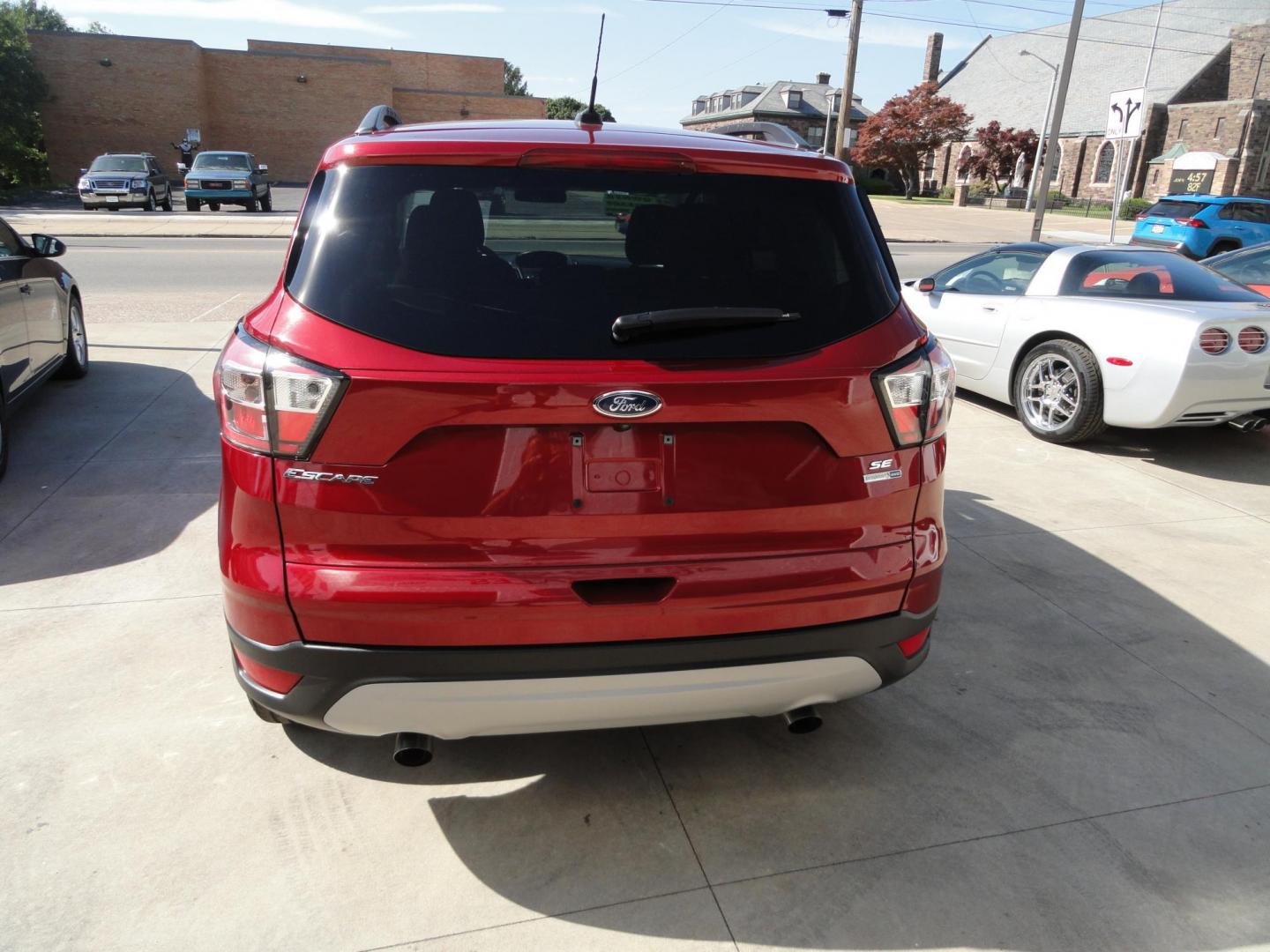 2018 Ruby Red Metallic /Greystone Ford Escape SE 4WD (1FMCU9GD1JU) with an 1.5L L4 DOHC 16V engine, 6A transmission, located at 827 W 26th Street, Erie, PA, 16508, (814) 455-3401, 42.105431, -80.090942 - Thanks for looking at our low mileage accident free one owner new vehicle trade. This is the SE model with all wheel drive, power drivers seat, Bluetooth and lots more including both keys and remotes, the owner's manuals and the original floor mats. A full service was just completed in our service d - Photo#4