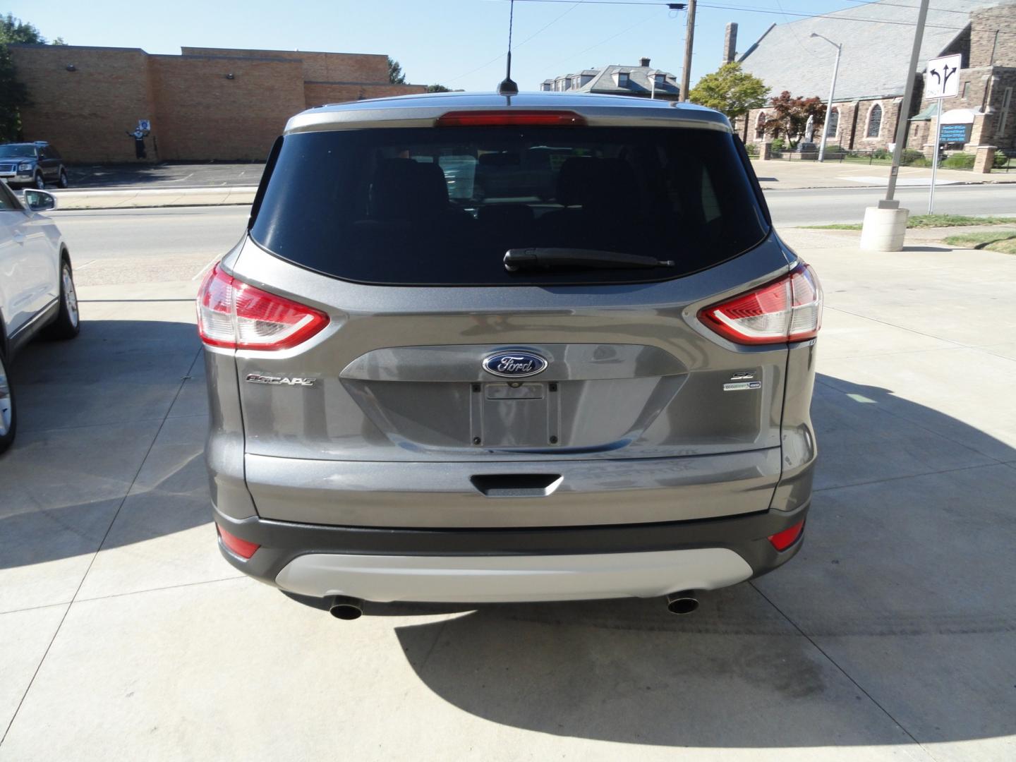 2014 Sterling Gray Metallic /Greystone Ford Escape SE 4WD (1FMCU9GX6EU) with an 1.6L L4 DOHC 16V engine, 6-Speed Automatic transmission, located at 827 W 26th Street, Erie, PA, 16508, (814) 455-3401, 42.105431, -80.090942 - Thanks for looking at our low mileage one owner accident-free recent arrival. This is the SE model with four-wheel drive, power seat, back up camera, Bluetooth, both keys and remotes, the owner's manuals and the factory floor mats. A complete service was just done in our service department and it's- Photo#4