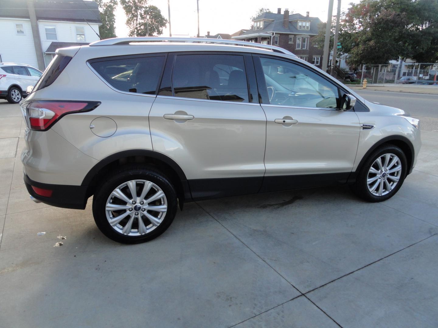 2017 White Gold Metallic /Black Ford Escape Titanium 4WD (1FMCU9J97HU) with an 2.0L L4 DOHC 16V engine, 6-Speed Automatic transmission, located at 827 W 26th Street, Erie, PA, 16508, (814) 455-3401, 42.105431, -80.090942 - Thanks for looking at our extra clean accident and rust free two owner recent arrival. This is the top-of-the-line Titanium four-wheel drive model that's in like new condition with no paint or body damage and the nonsmoker interior is like new also, plus it comes with all the options available inclu- Photo#3