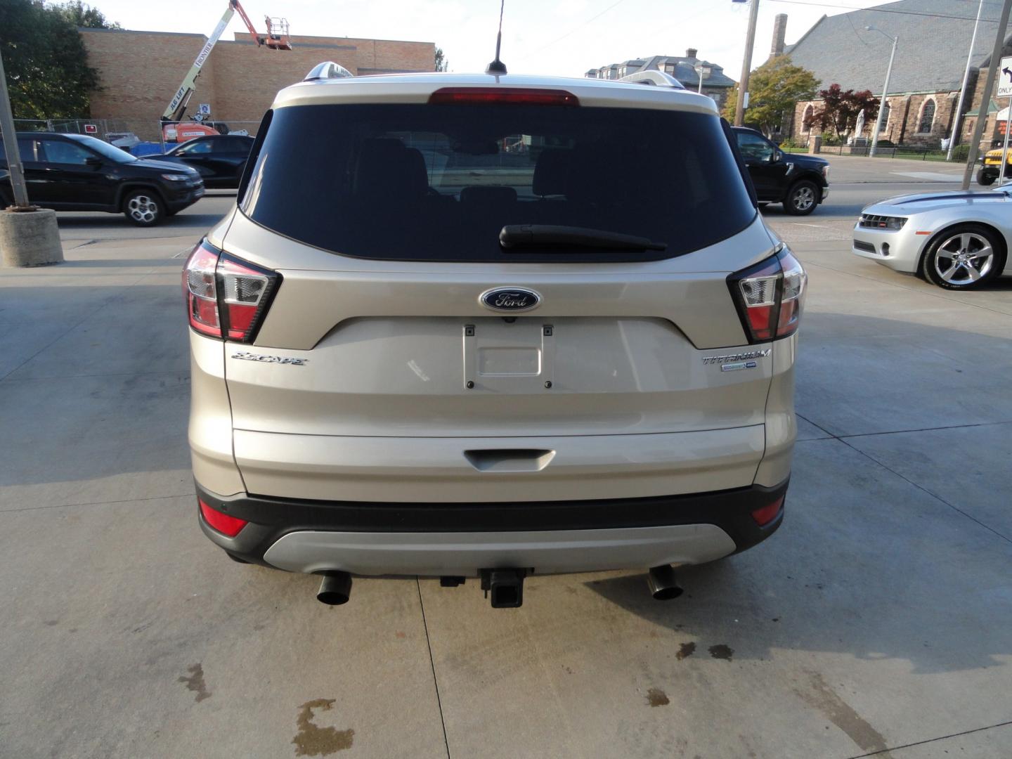 2017 White Gold Metallic /Black Ford Escape Titanium 4WD (1FMCU9J97HU) with an 2.0L L4 DOHC 16V engine, 6-Speed Automatic transmission, located at 827 W 26th Street, Erie, PA, 16508, (814) 455-3401, 42.105431, -80.090942 - Thanks for looking at our extra clean accident and rust free two owner recent arrival. This is the top-of-the-line Titanium four-wheel drive model that's in like new condition with no paint or body damage and the nonsmoker interior is like new also, plus it comes with all the options available inclu- Photo#4