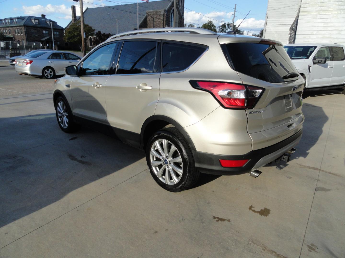 2017 White Gold Metallic /Black Ford Escape Titanium 4WD (1FMCU9J97HU) with an 2.0L L4 DOHC 16V engine, 6-Speed Automatic transmission, located at 827 W 26th Street, Erie, PA, 16508, (814) 455-3401, 42.105431, -80.090942 - Thanks for looking at our extra clean accident and rust free two owner recent arrival. This is the top-of-the-line Titanium four-wheel drive model that's in like new condition with no paint or body damage and the nonsmoker interior is like new also, plus it comes with all the options available inclu- Photo#5